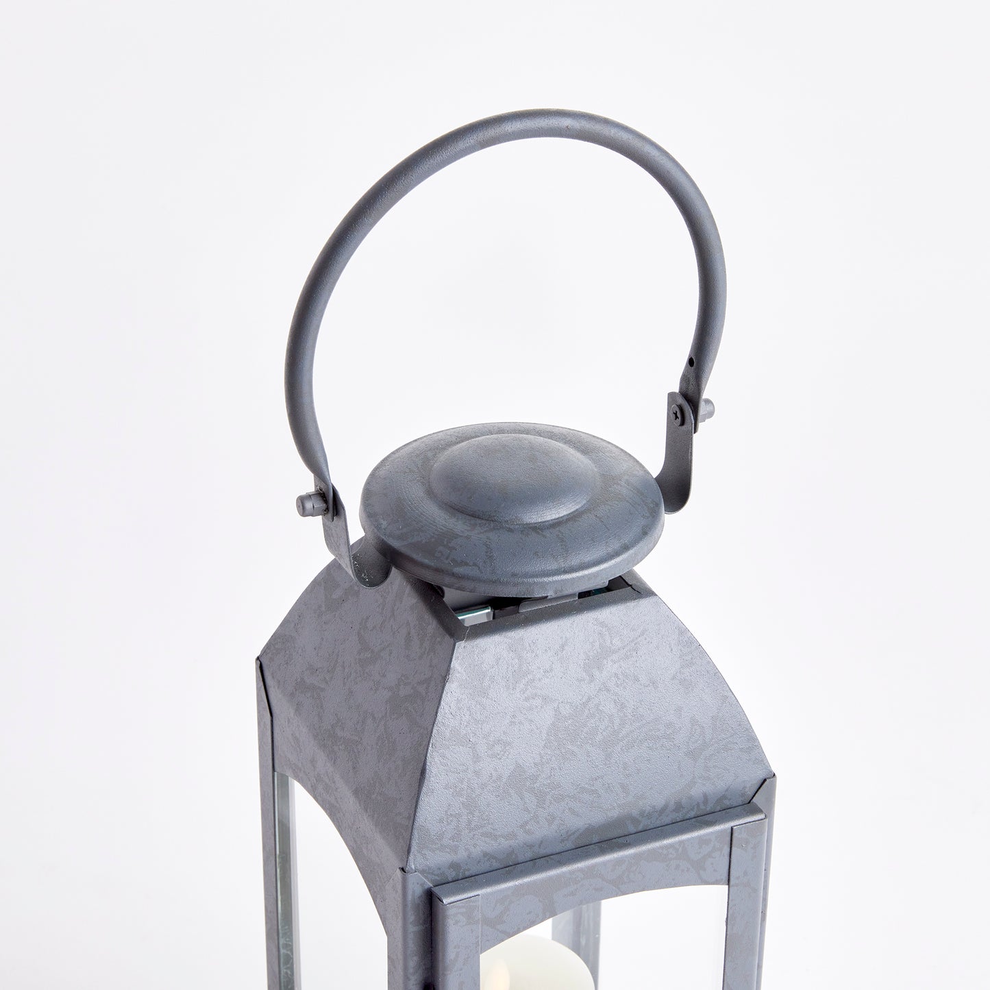 Crafted with a chic faux zinc finish and soft grey tone, this outdoor lantern brings a touch of old European style to your outdoor space. Its vintage-inspired design is true to the authentic qualities of the lantern, perfect for creating a sophisticated ambiance. Enhance your outdoor decor with the Antoinne Outdoor Gray Lantern Small and add a charming European touch.