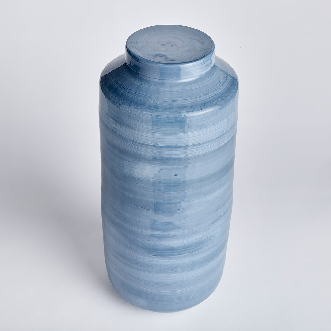 Expertly crafted with enameled iron, this ginger jar combines lightweight durability with intricate hand-painted details. A refined, horizontal swirl design and coastal-inspired blue gray palette showcase the modern artistry of this timeless piece. Each jar is carefully painted by hand, resulting in a unique and elegant creation. Embrace the sophistication and beauty of this piece as it adds a touch of art to your home decor.