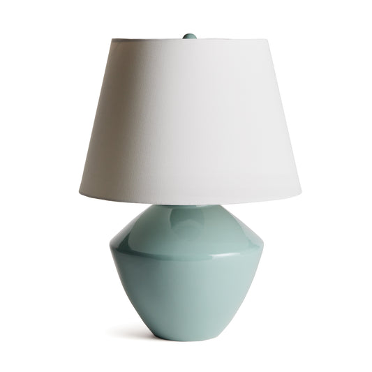 This handsome lamp has a classic silhouette. The body was crated from a centuries old wooden mold. We brought it back to life in a rich celadon finish. Topped with a tapered fabric shade, it makes a dynamic, storied lamp for family room, study or bedroom.