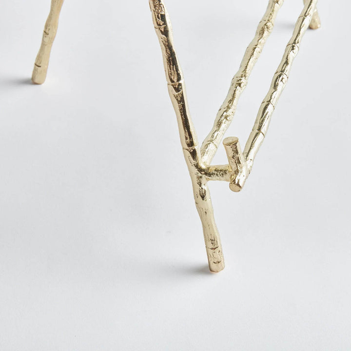 Expertly designed to securely hold heavy objects such as platters, cookbooks, and small pieces of art, the Gold Easel Large is the perfect choice for versatile display needs. Featuring a classic design with elegant gold bamboo-like details, this easel adds a touch of timeless sophistication to any setting. Its sturdy structure ensures the protection of your items while adding a professional and educational element to your display.