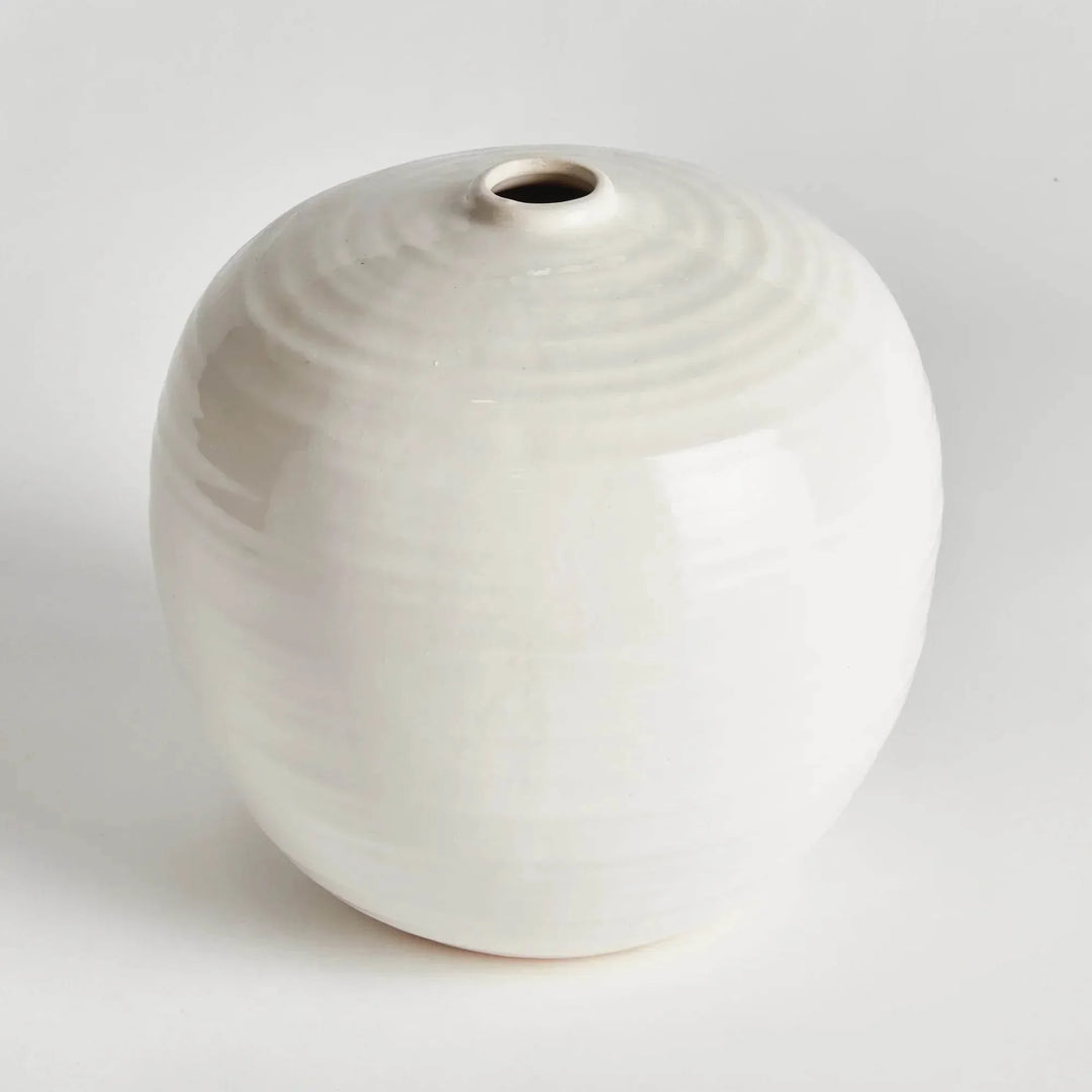 Small oatmeal stoneware vase viewed at an angle, with glossy glaze and rings around its rounded shoulder | Modern Organic