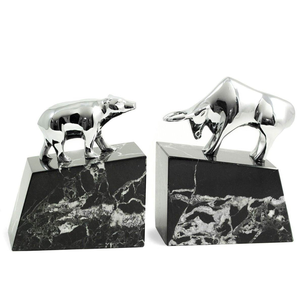 Silver plated bull and bear sculptures on black marble bases, angled view highlighting veining and sculptural detail – Executive