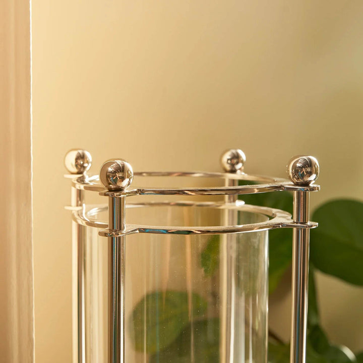 Top detail of extra tall chrome hurricane candle holder with polished silver finials
