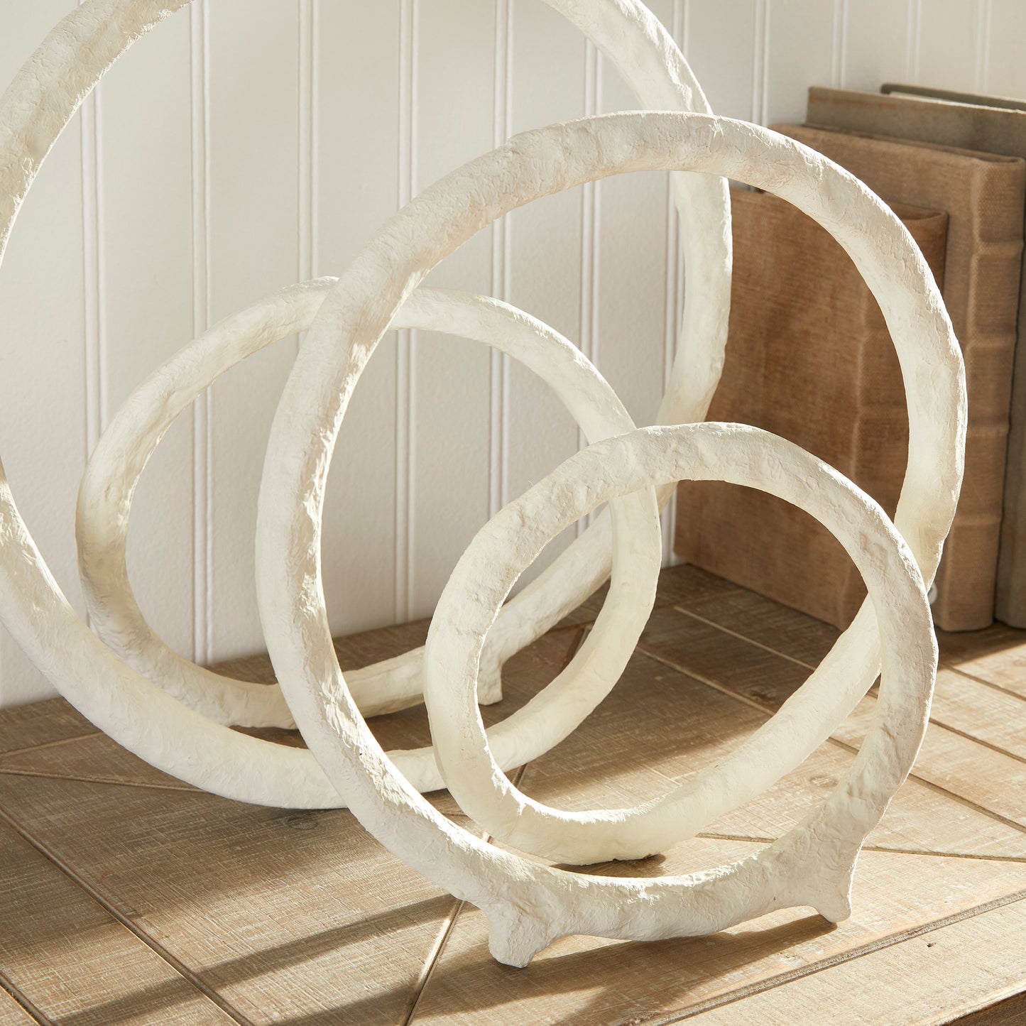 These two coordinating sculptures feature a modern matte white powder coat, adding sophistication to any space. Made of cast aluminum, they are both durable and aesthetically pleasing, with subtle coastal influences. Place them on a bookshelf, console, or mantel to instantly elevate your home decor.