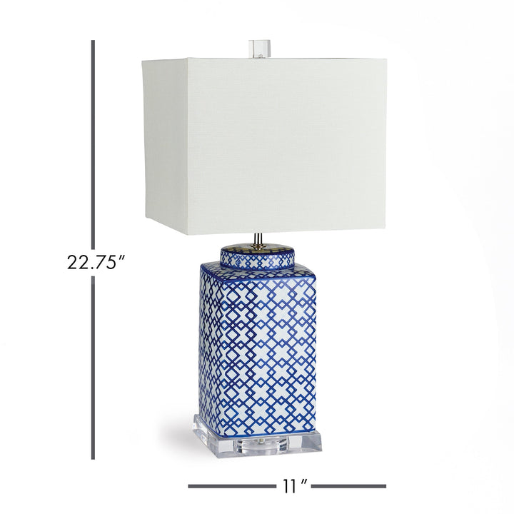 This blue and white table lamp features a striking square shape and bold pattern, making it an elegant choice for any room. Whether placed on a side table, console, or shelf, it is sure to brighten up the space. With an acrylic stand, ceramic base, and linen shade, this lamp is the perfect blend of style and functionality.