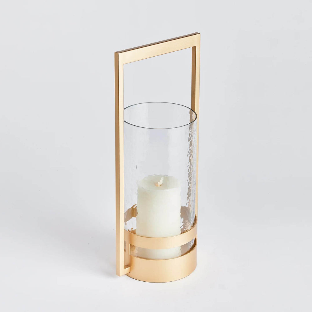 The Atrio Gold Hurricane Small is expertly crafted with a balanced blend of metal and glass, making it a standout piece. Its warm gold finish adds an elegant touch to its sleek design, making it the perfect addition to any modern, open space. The impressively sized hurricane guarantees to make a statement in any interior.