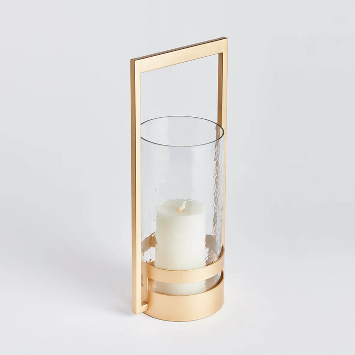 The Atrio Gold Hurricane Small is expertly crafted with a balanced blend of metal and glass, making it a standout piece. Its warm gold finish adds an elegant touch to its sleek design, making it the perfect addition to any modern, open space. The impressively sized hurricane guarantees to make a statement in any interior.