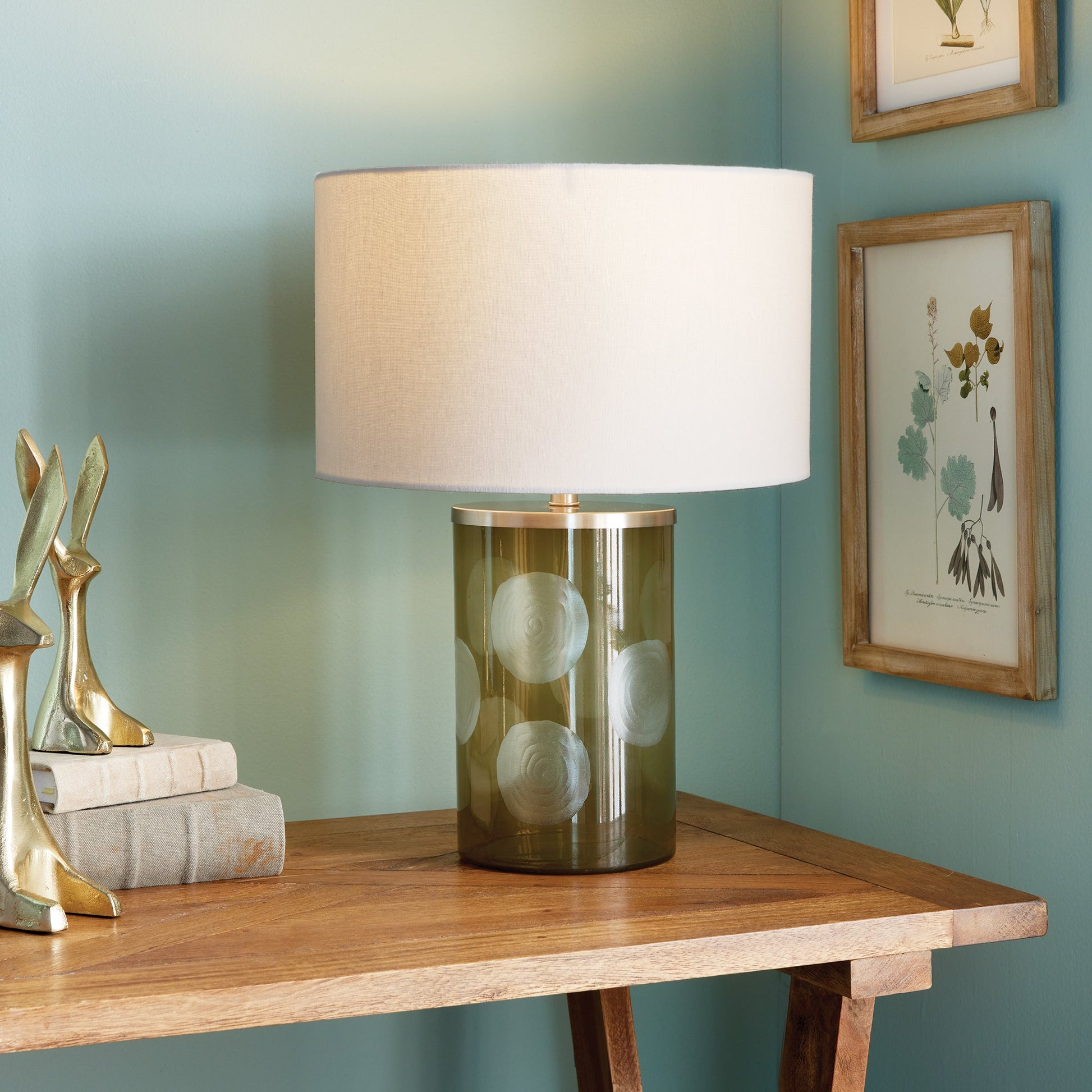 Enhance your home with the Norman Polka Dot Table Lamp, a playful addition that brings a touch of whimsy to any space. Crafted from soft taupe glass and featuring oversized etched polka dots, this lamp is finished with a bright white linen shade, making it a perfect accent for your console, desk, or side table.