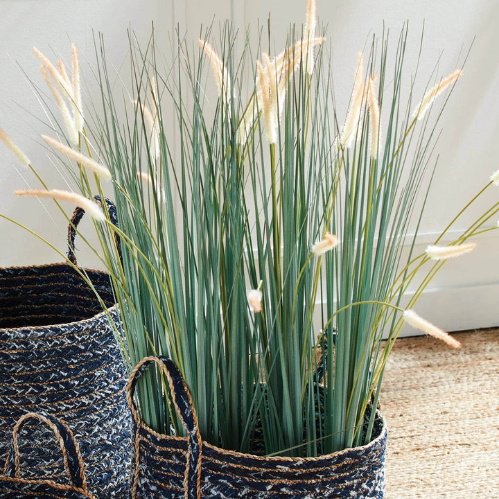 Faux field grass drop-in displayed in a woven basket, showing realistic green blades with golden tips, perfect for home accents – Modern Organic.

