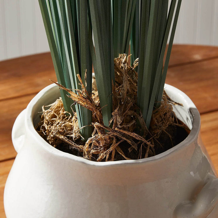 Close-up of the faux field grass drop-in root ball, showing realistic green blades and base detail for easy styling in planters – Modern Organic.


