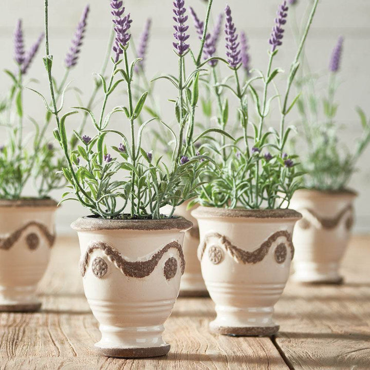 Close-up of lifelike faux lavender stems and blooms with realistic foliage and soft purple color – French Country.

