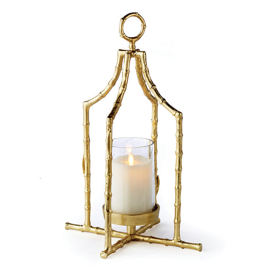 The Gold Hurricane Lantern is perfect for adding elegance to any space with its beautiful seeded glass insert and elegant gold bamboo design. Its loop feature adds both height and sophistication, creating an elegant focal point that draws the eye upward. Experience a statement of style and sophistication with this lantern.