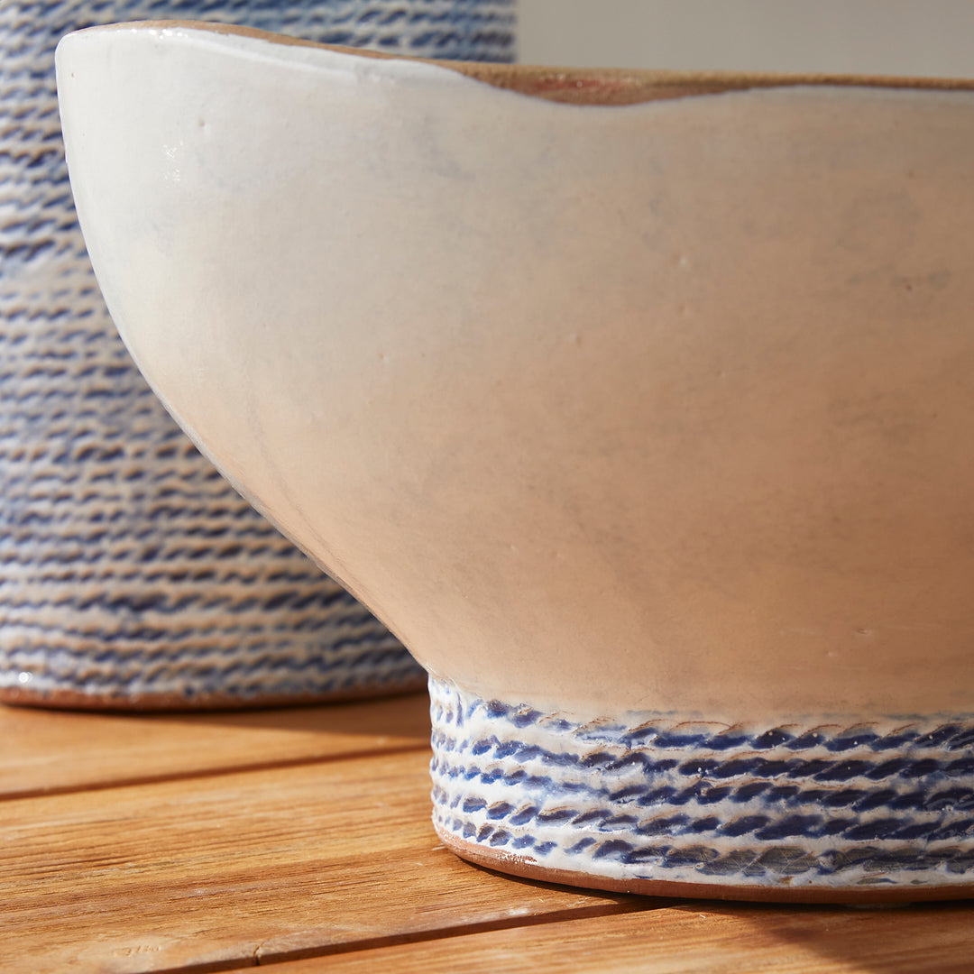 Our Coastal Themed Decorative Bowl features a Grecian blue striped design and exposed clay rim, evoking the beauty of the Mediterranean. The fully glazed interior adds a touch of luxury and elegance, making it a perfect addition to any coastal-themed decor. Whether used as a stunning centerpiece or to display fresh limes, this versatile bowl is sure to impress.