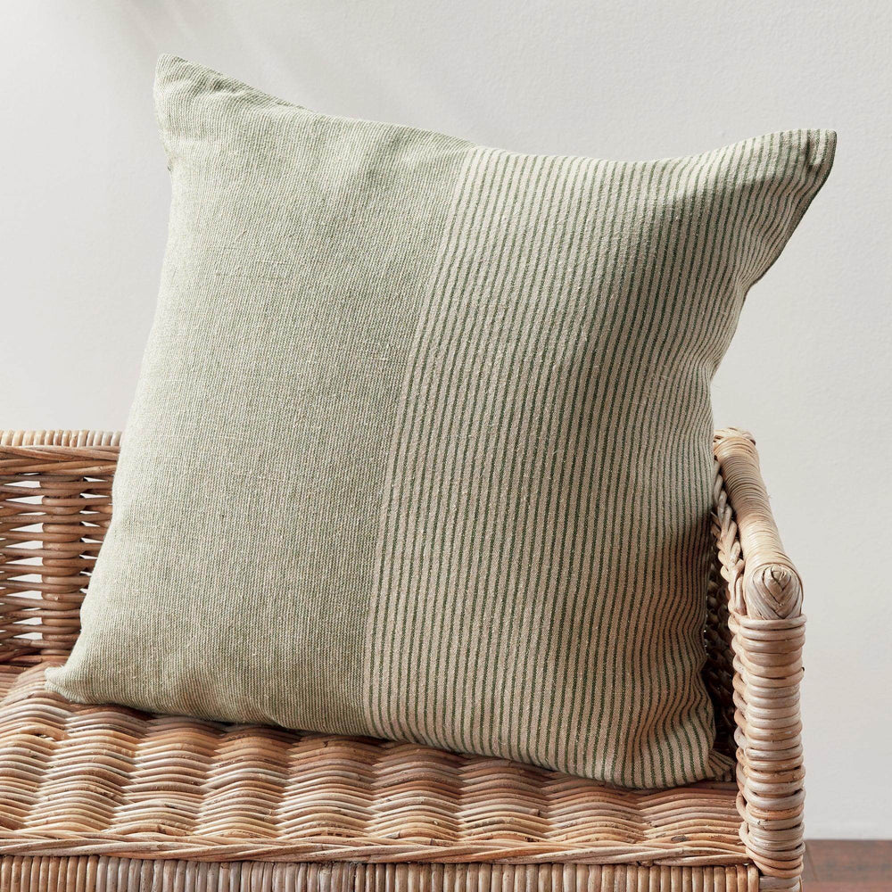 Lifestyle: 24-inch flax linen pinstripe pillow in green and tan on wicker chair, natural woven texture – Modern Farmhouse.
