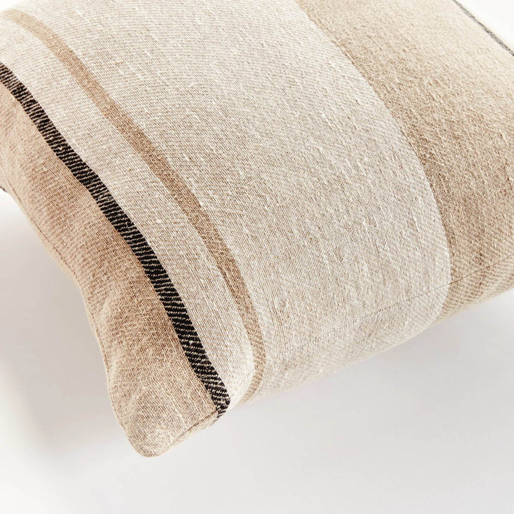 Corner detail of 20-inch flax linen striped pillow, tan and gray tones with woven texture and tailored seams – Coastal.