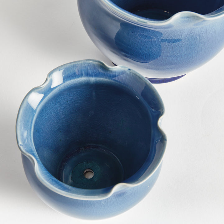 Blue ceramic planter pair viewed from above, showing the glazed interiors, wavy rims and drainage hole. Classic Transitional