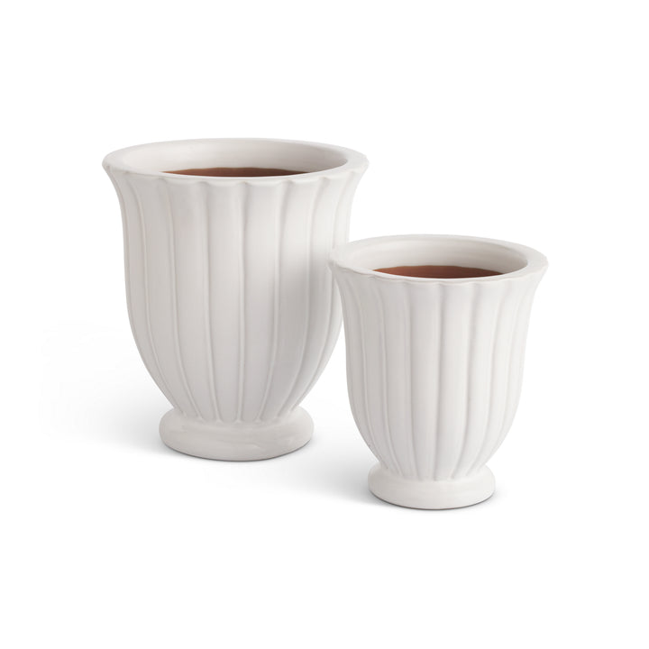 Set of two white fluted ceramic planter pots with pedestal bases and ribbed detailing for indoor or outdoor use – Transitional style.