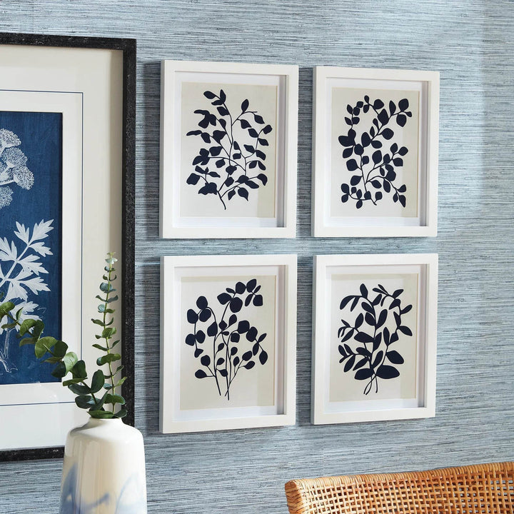 Close-up of navy botanical framed prints styled with adjacent wall art.

