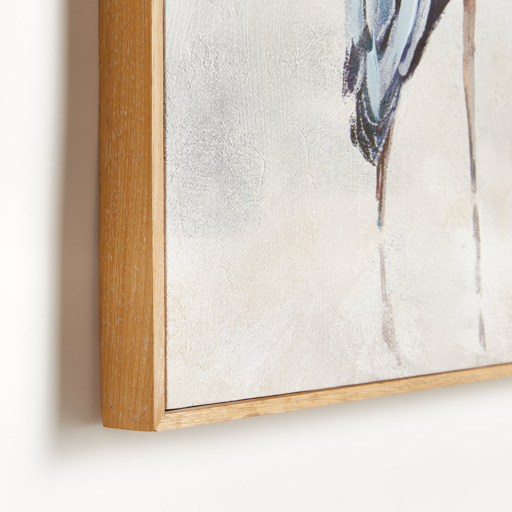 Close detail of a heron canvas giclee print showing the bird's legs and a natural walnut wood frame, Coastal Transitional