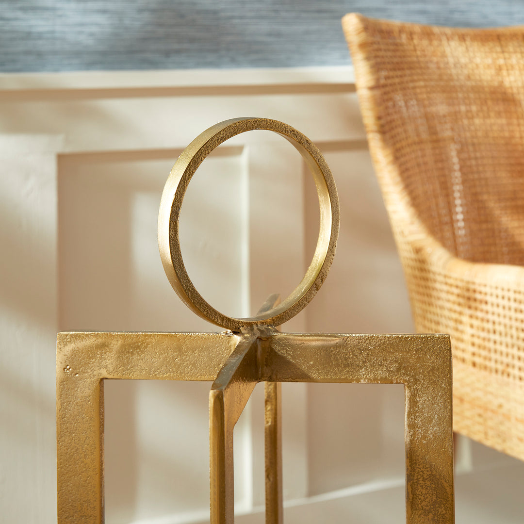 Close view of antique gold geometric metal lantern ring handle and textured frame detail, sculptural lantern accent Transitional style
