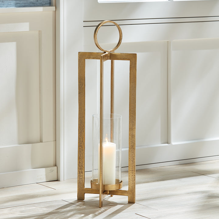 Close view of antique gold geometric metal lantern circular handle and textured top frame detail, Transitional style
