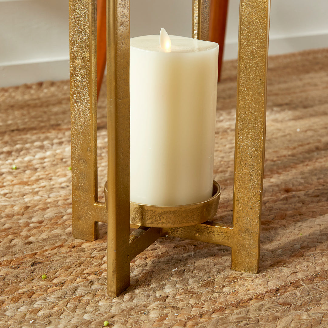 Close view of antique gold geometric metal lantern candle platform and lower frame detail with pillar candle, Transitional style
