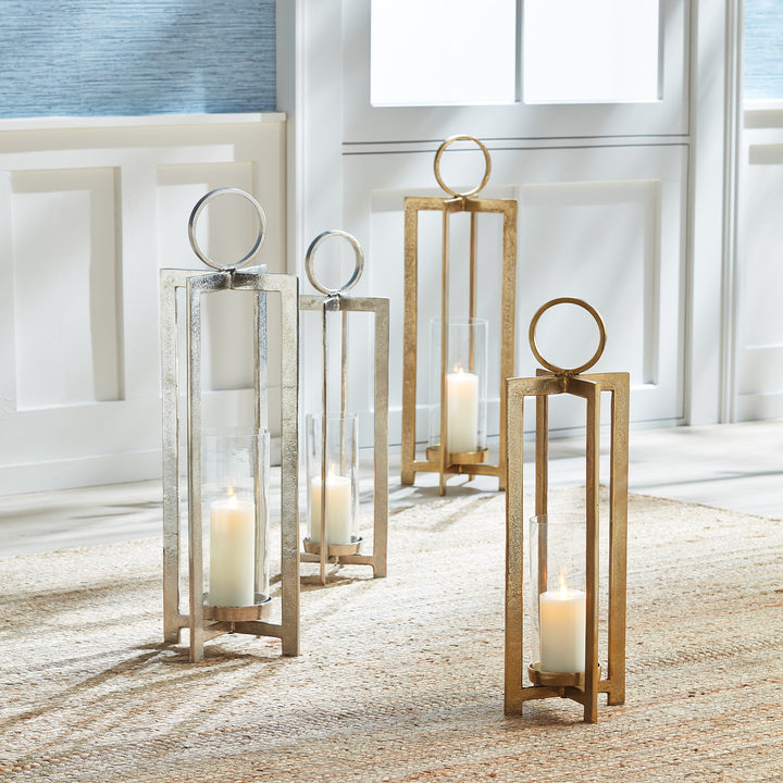 Mixed antique gold and antique silver geometric metal lantern collection in assorted sizes styled together on floor, Transitional style
