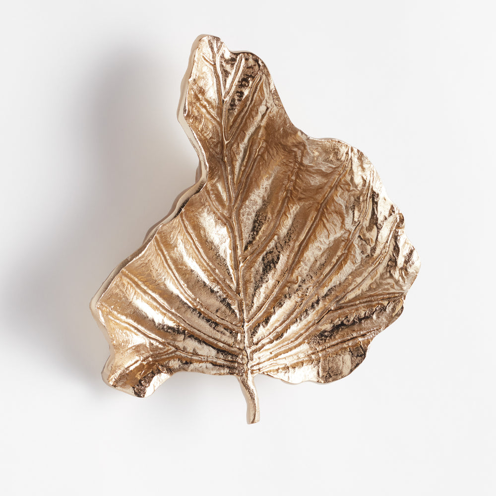 Cast aluminum wall leaf sculpture shown at angled view to highlight sculptural depth and curled edges in champagne gold finish – luxury metallic wall accent