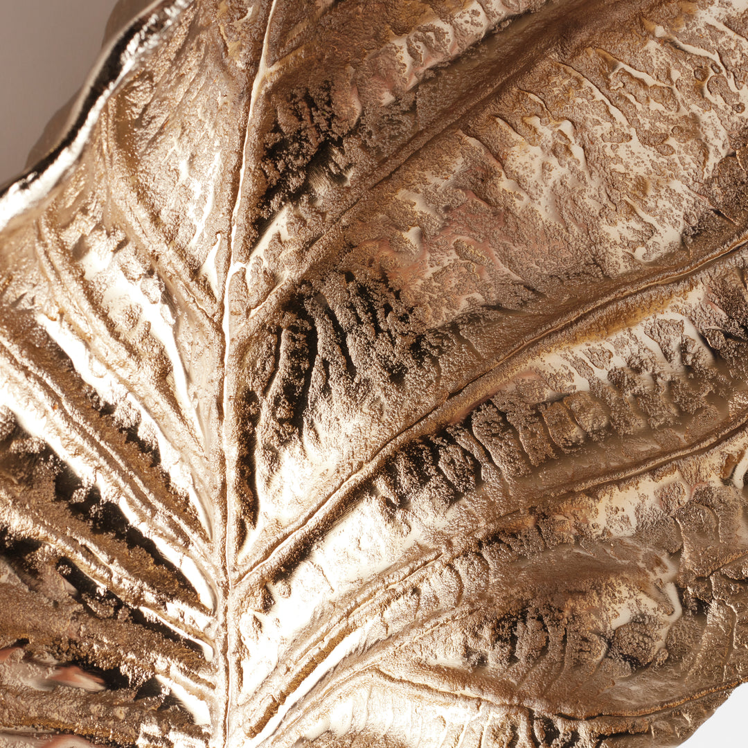Close-up of gilded leaf wall art texture, highlighting naturalistic veining and hand-applied metallic finish