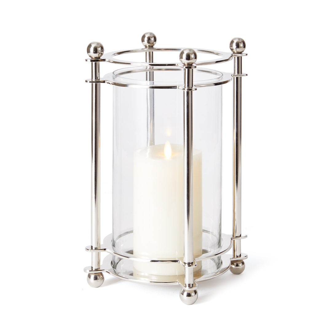 Glass and chrome hurricane with pillar candle in modern classic living room decor

