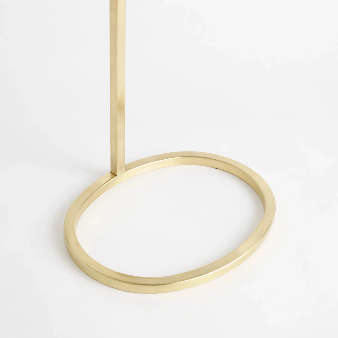 Gold steel accent table with open oval ring base and slender frame shown base detail Modern Glam style