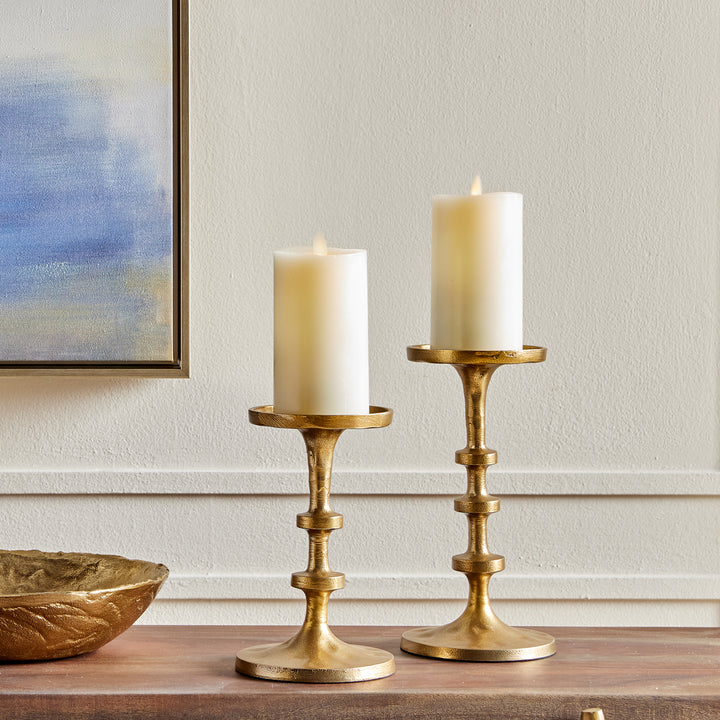 Gold aluminum candle holders with stacked detailing styled on a console table arrangement – Transitional