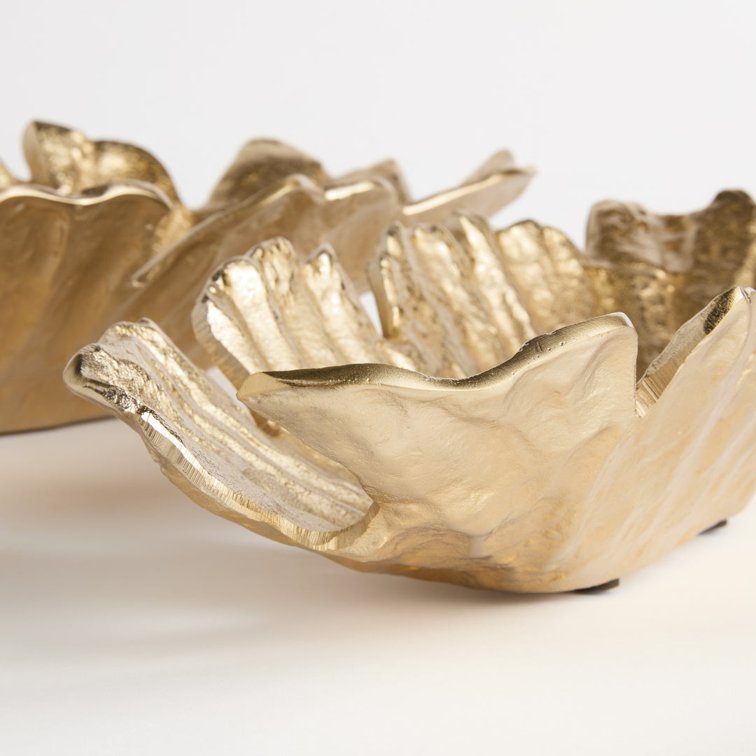 Side view close-up of sculpted edge and inner contour on gold cast aluminum oval bowl, showing handcrafted depth and form – Contemporary style.