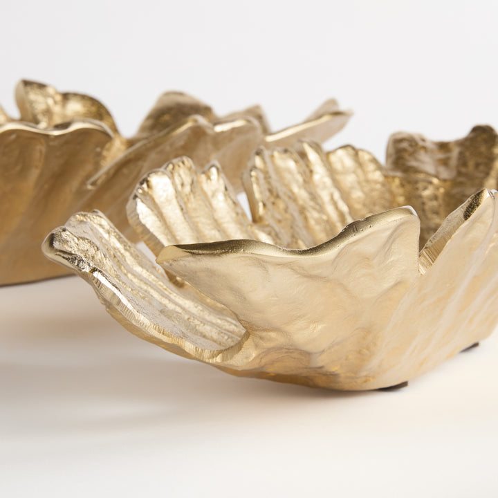 Side view close-up of sculpted edge and inner contour on gold cast aluminum oval bowl, showing handcrafted depth and form – Contemporary style.