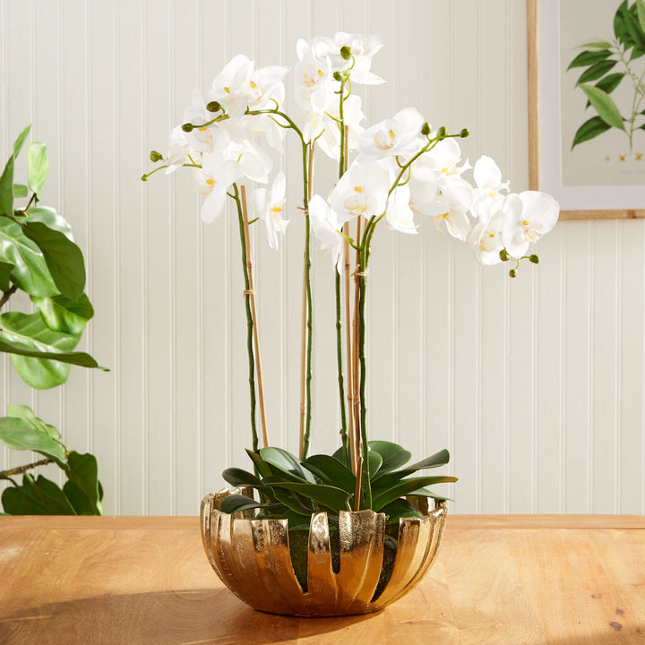 Gold decorative metal bowl used with white orchid drop-in arrangement, modern centerpiece for dining or kitchen table.

