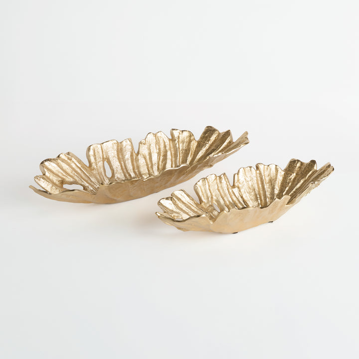 Set of two gold cast aluminum decorative oval bowls with organic ridged edges, displayed side by side on white surface – Transitional style.