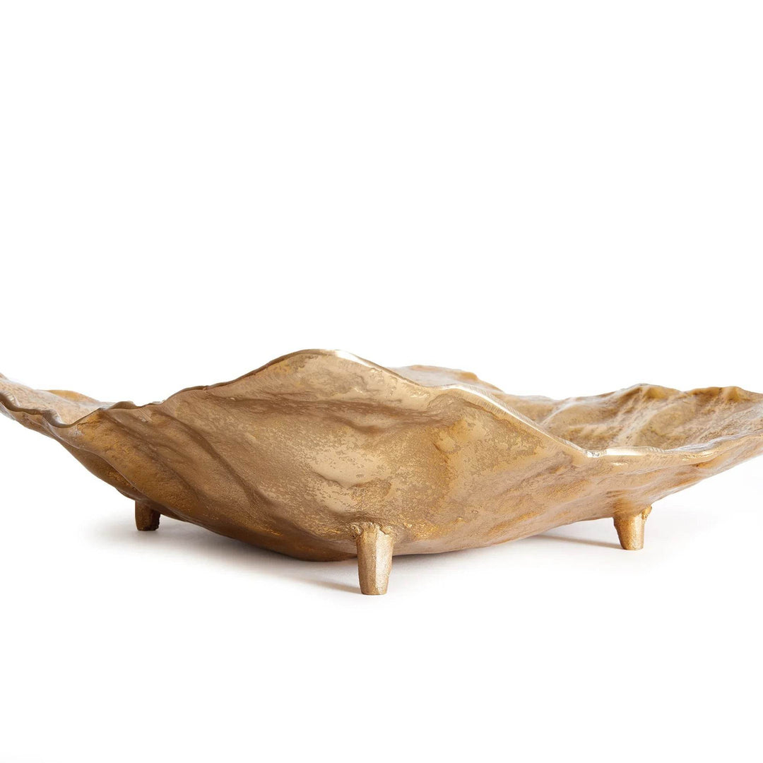 Side profile of a gold cast aluminum decorative tray with integrated raised feet and softly irregular sculptural rim