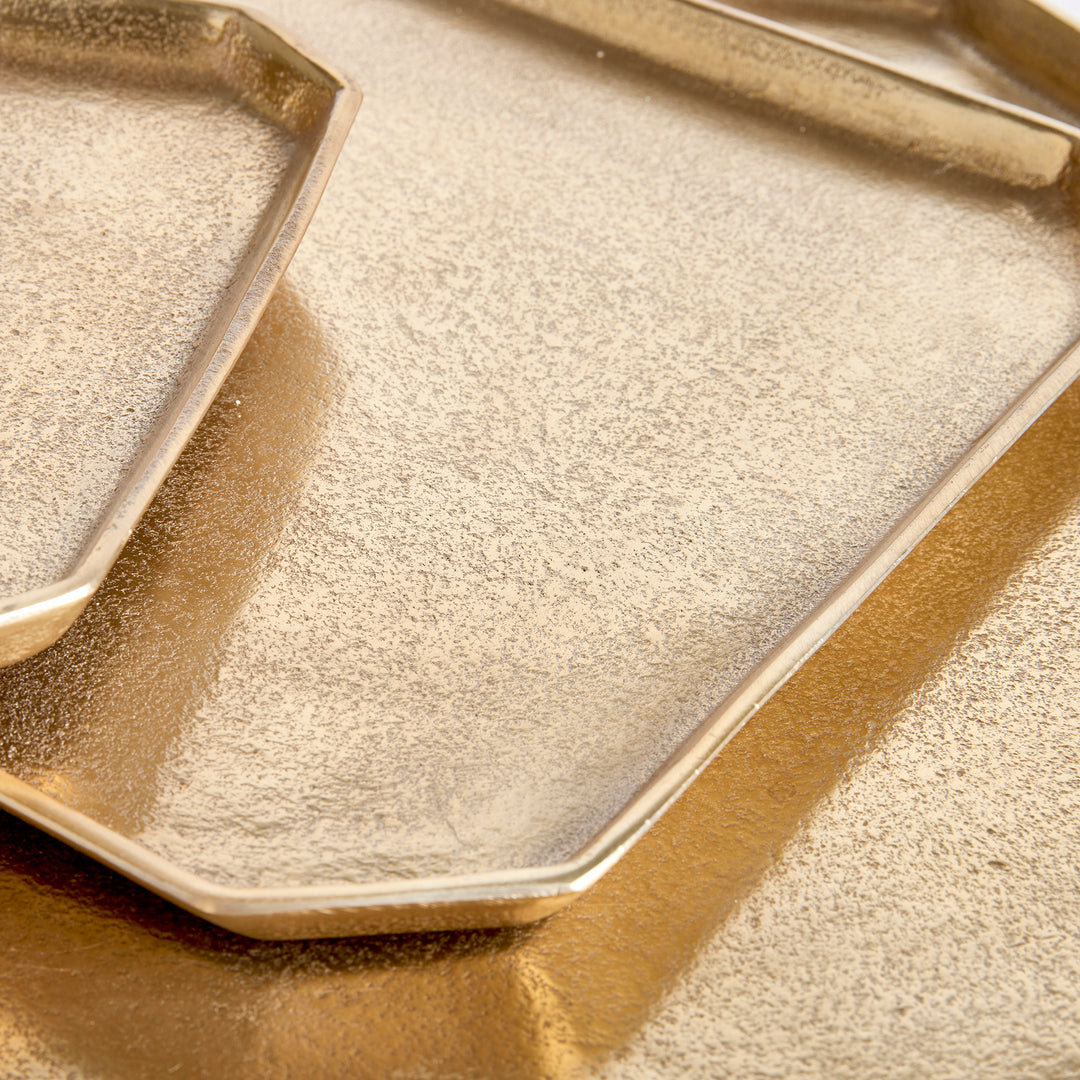 Close-up of textured gold cast aluminum serving tray showing clipped corner, shallow rim and gold finish, Transitional style