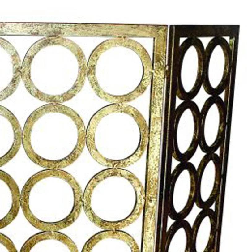 Angled close-up of handcrafted gold iron fire screen showing textured circle motif – Old World Glam.

