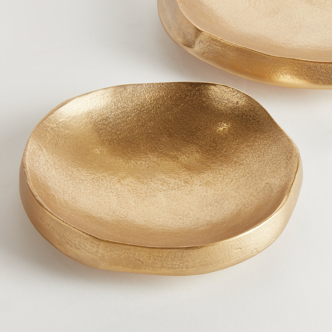 Close view of a gold decorative bowl showing its textured aluminum interior, round outline and thick profile - Modern Organic