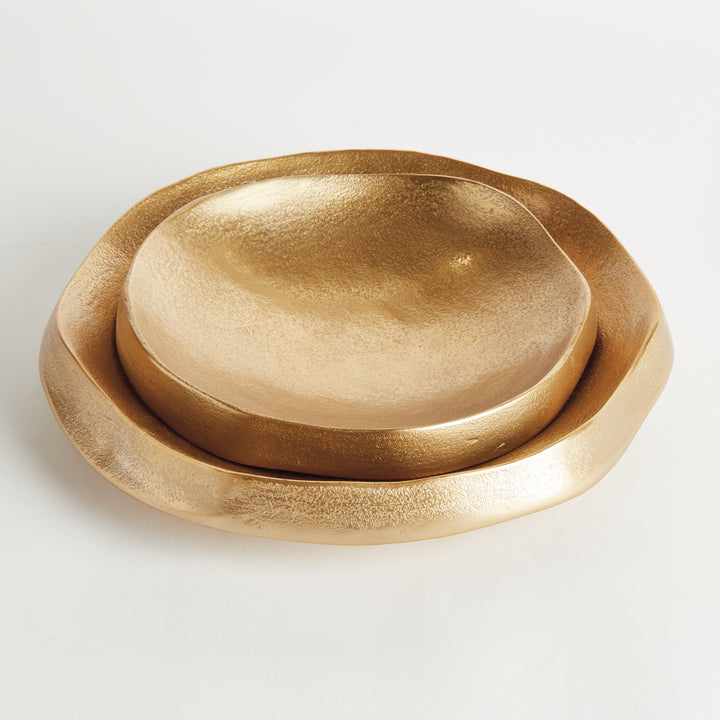 Two gold decorative aluminum bowls stacked together showing organic round rims and softly textured interiors - Modern Organic