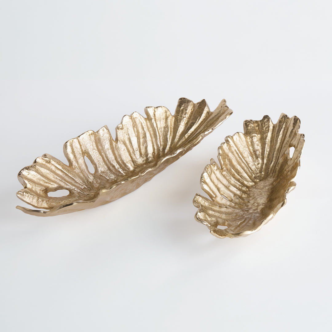 Overhead view of gold cast aluminum decorative oval bowls with leaf-like ridges and sculpted asymmetry, styled as tabletop accents – Modern Organic.