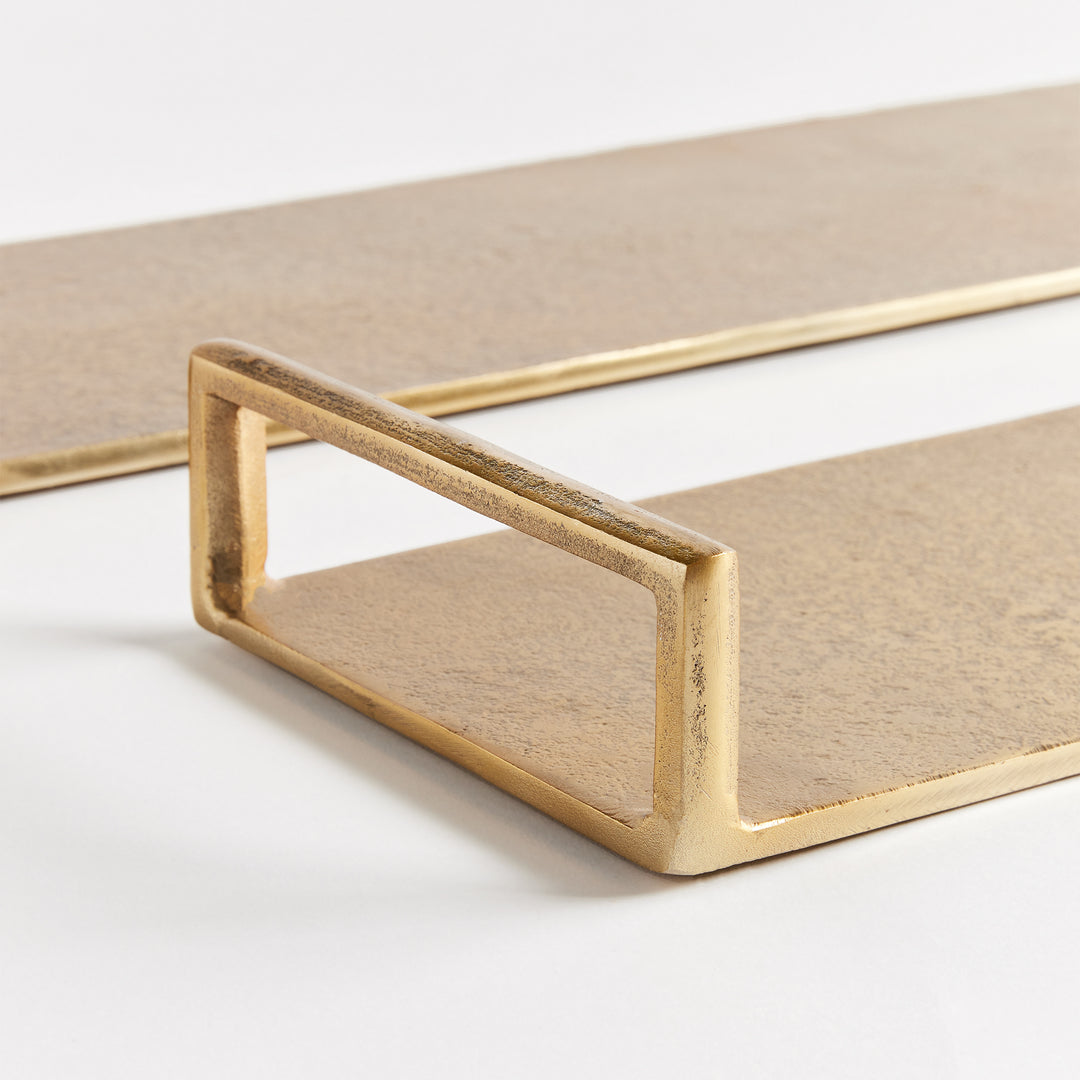 Close-up of gold cast aluminum decorative tray with textured surface and open rectangular end handle detail – Transitional.
