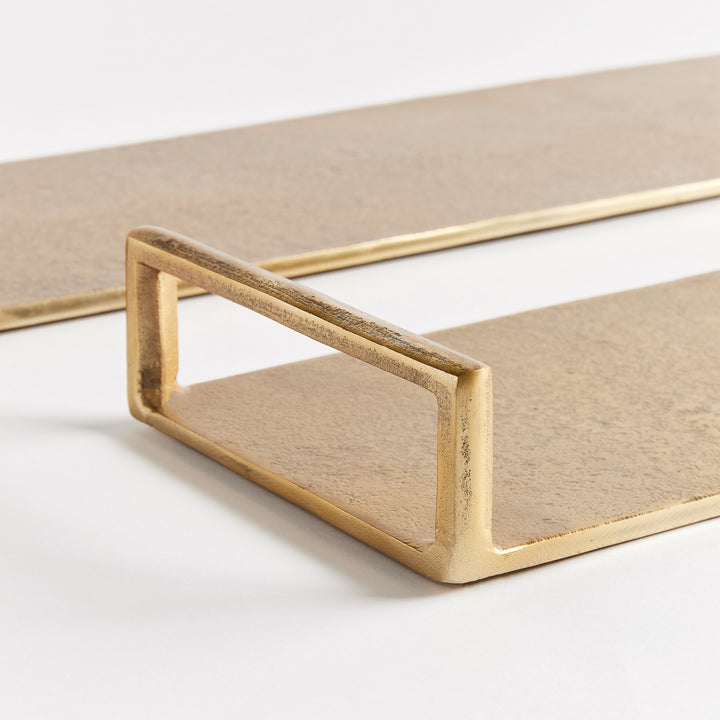 Close-up of gold cast aluminum decorative tray with textured surface and open rectangular end handle detail – Transitional.