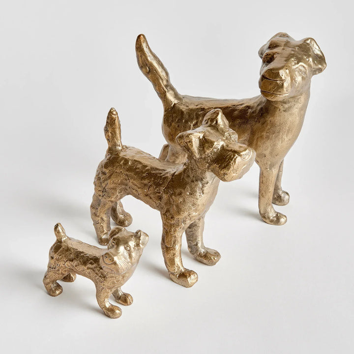Small gold dog figurine with textured surface and expressive form, close-up of cast aluminum decorative accent – Transitional