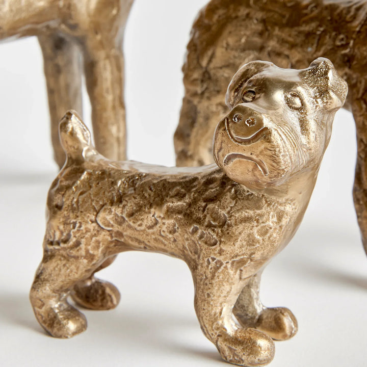 Gold cast aluminum dog figurines viewed from above showing sculptural texture and dimensional form, decorative accents – Transitional