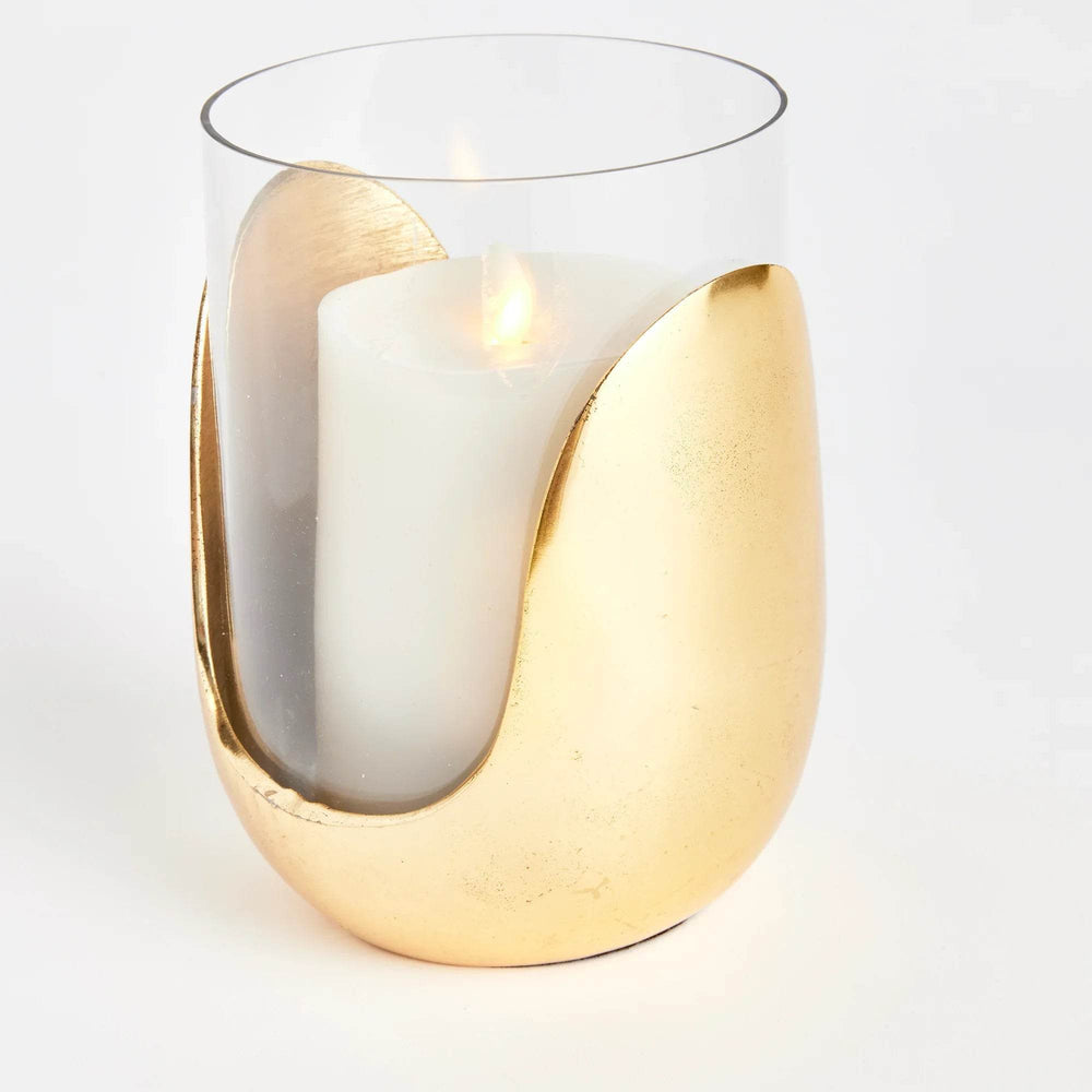 Contemporary gold and glass hurricane candle holder shown at an angle with LED pillar candle inside