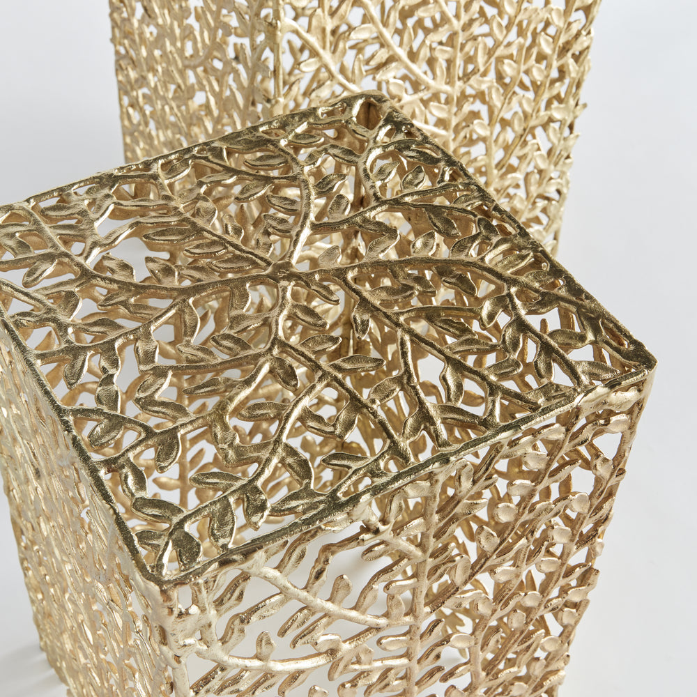Close-up of gold leaf cutout tabletop on vine motif accent table, modern botanical decor