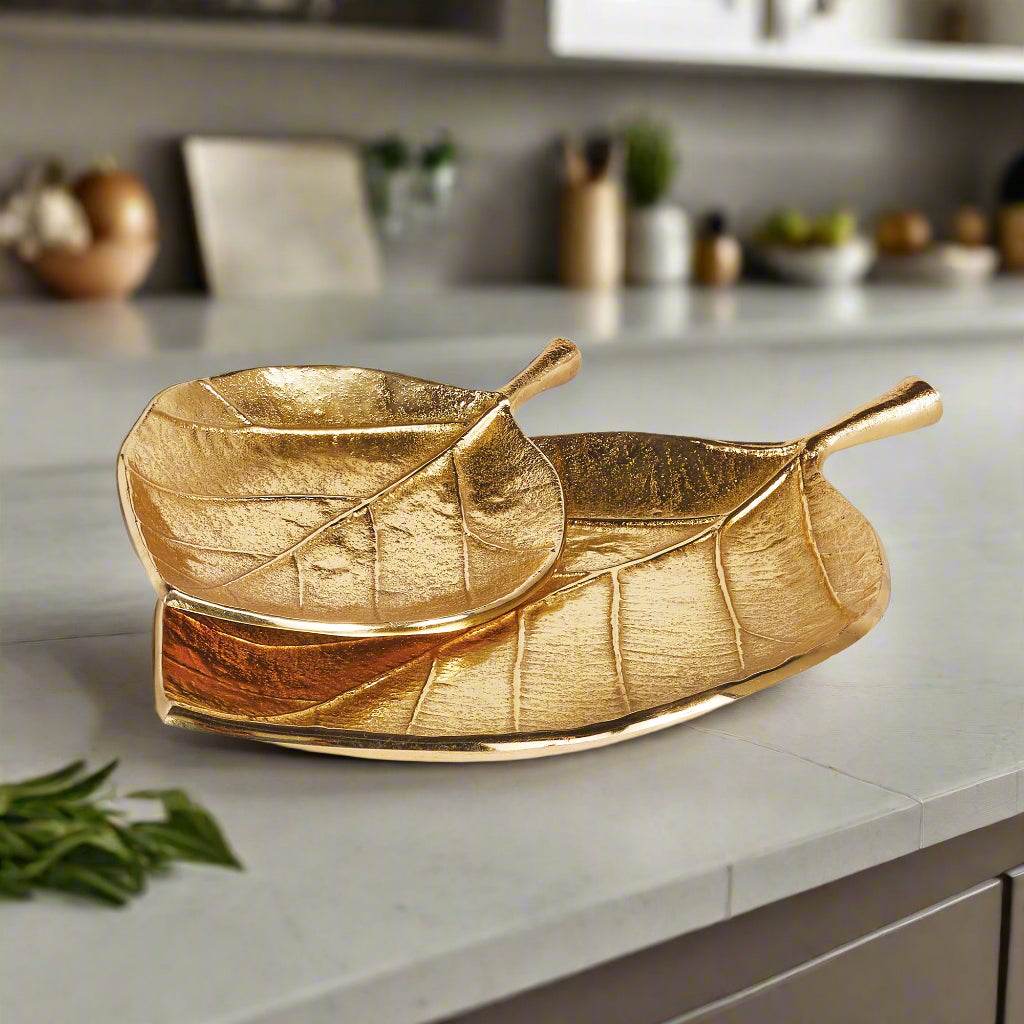 Gold leaf trays styled on a kitchen counter with natural light and surrounding decor – Wabi-Sabi.

