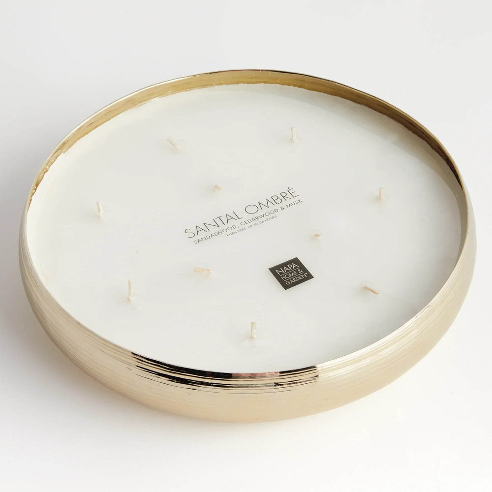 Gold metal 10-wick candle in a shallow round vessel, styled as a centerpiece for tables, consoles, or shelves – Modern Organic.

